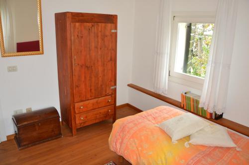 una camera con un letto e una finestra e una porta in legno di B&B LE ORTENSIE a Castagnole