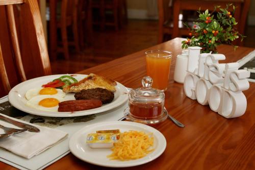 a table with two plates of breakfast food on it at Lockerbie Lodge in Vryburg