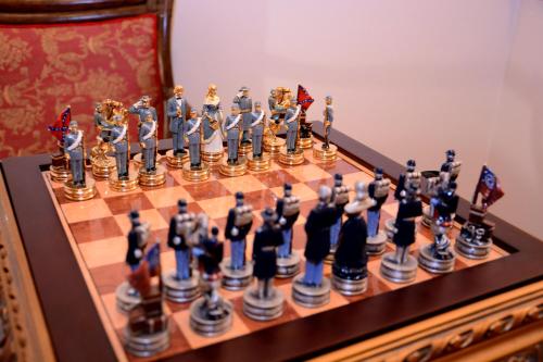 a chess set on a wooden chess board at Arbia Dorka Heritage Palace in Varaždin