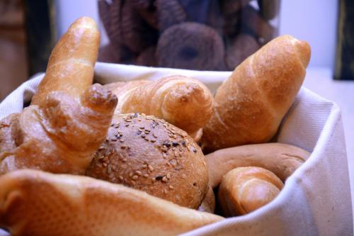 a bowl of bread and rolls in a basket at Arbia Dorka Heritage Palace in Varaždin