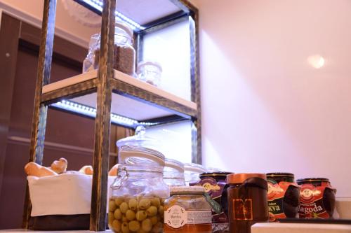 a shelf with jars of food on a table at Arbia Dorka Heritage Palace in Varaždin