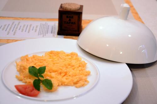a plate of food on a table with a bowl of food at Arbia Dorka Heritage Palace in Varaždin