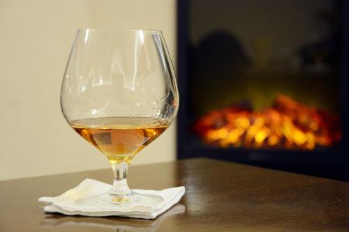 a glass of wine sitting on top of a table at Arbia Dorka Heritage Palace in Varaždin