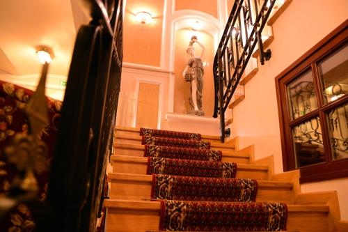 a set of stairs in a building with a statue at Arbia Dorka Heritage Palace in Varaždin