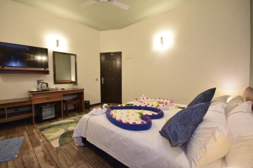 a room with a couch with a cake on it at Island Home Inn in Ukulhas