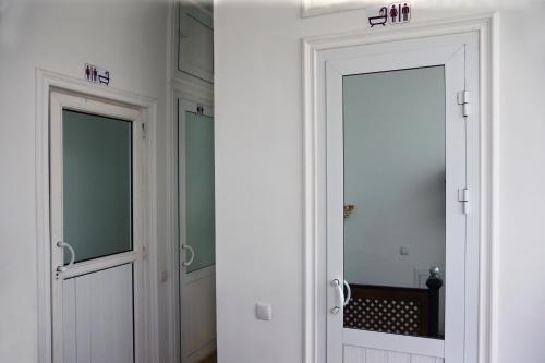 two doors in a room with a mirror at Amir Hostel in Samarkand