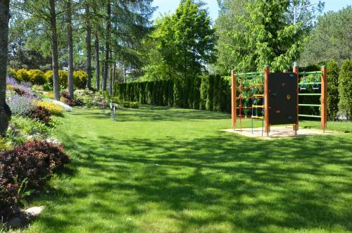a garden with a playground in the middle of a yard at Hotel Avangarda in Różan