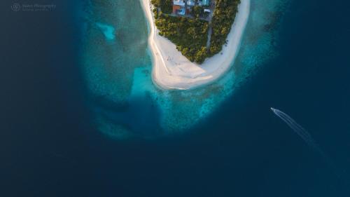 an aerial view of a boat in the water at Island Home Inn in Ukulhas