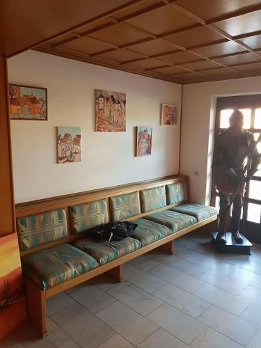 a couch in a room with a person looking out the window at Hotel-Gasthof "Alter Ritter" in Rothenburg ob der Tauber