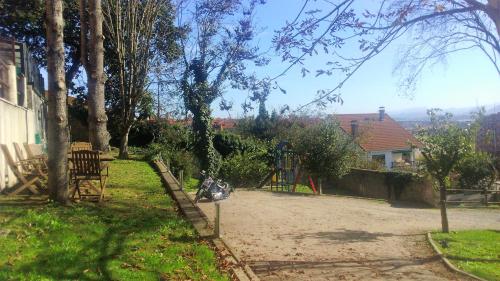 a yard with a playground with a motorcycle parked in it at Hotel San Millán in Santander
