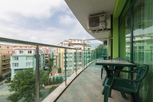a balcony with a table and chairs on a building at Hotel L&B- Free parking in Sunny Beach