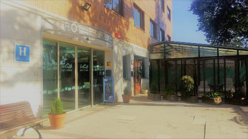 a store with a bench in front of a building at Hotel San Millán in Santander