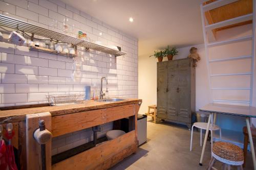 a kitchen with a sink and a counter top at Joans B&B in Zaandam