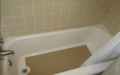 a white bath tub sitting next to a white toilet at Budget Inn Motel Dalhart in Dalhart