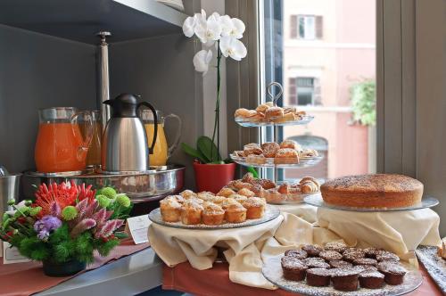 a buffet with various pastries and cakes on a table at Green Hotel in Vergiate