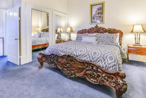 a bedroom with a large bed with a wooden frame at Chateau Orleans in New Orleans