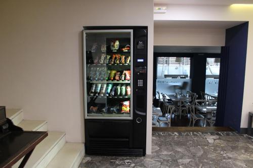 a black refrigerator with drinks in it in a restaurant at Galaxy Hotel in Athens