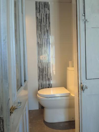 a bathroom with a toilet and a shower curtain at Casona Moya in Arequipa