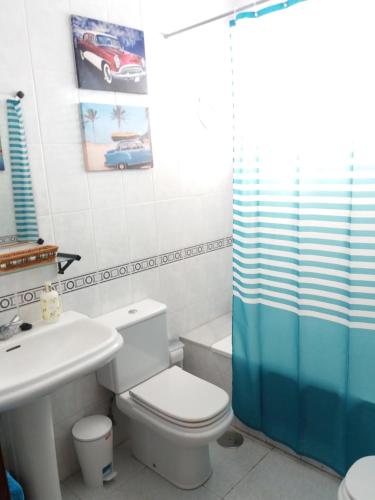 a bathroom with a toilet and a sink and a shower at Apartamento Esperanto in Las Lagunas