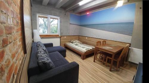 a living room with a couch and a table at NavyBlue Apartments in Gdynia