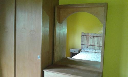 a mirror in a bedroom with a bed in it at Casa Picoco in San Bernardo