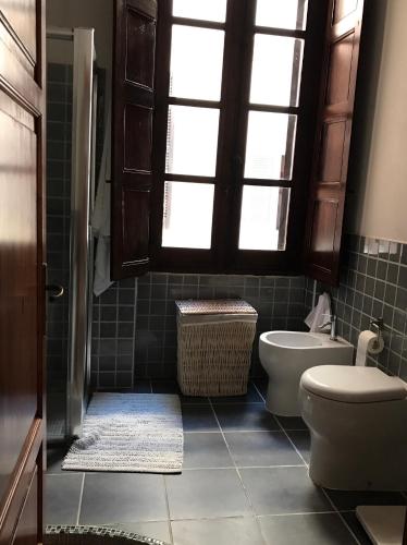 a bathroom with a toilet and a sink at Palazzo Bolasco in Alghero