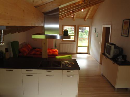 a kitchen with white cabinets and a stove top oven at Apart Dominika in Ried im Oberinntal