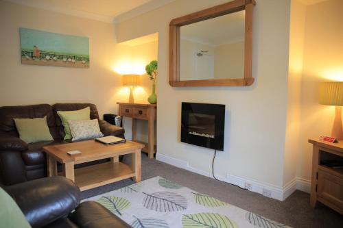 a living room with a couch and a mirror at Elizabeth House in Whitby