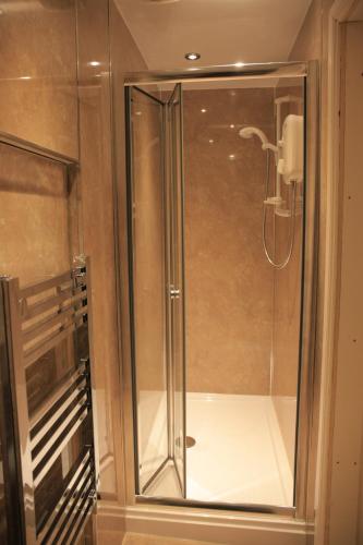 a shower with a glass door in a bathroom at Elizabeth House in Whitby