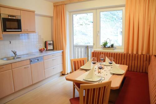 a kitchen with a table with wine glasses on it at Haus Waldhof in Ischgl