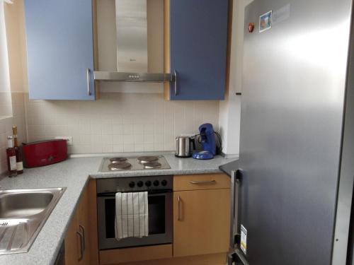 a kitchen with a stove and a refrigerator at Lotus in Trier
