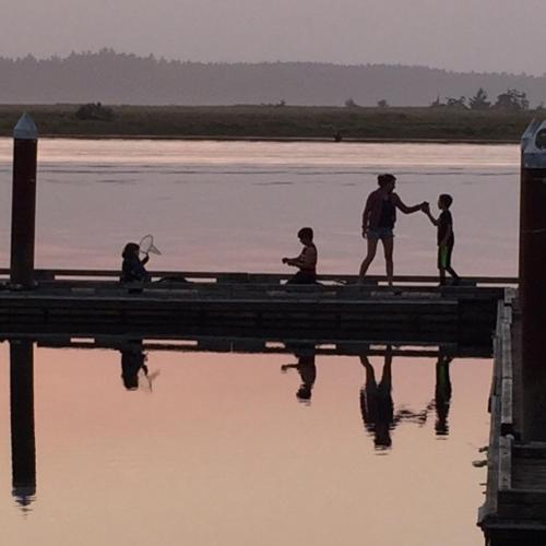 a group of people on a dock on the water at Wheeler on the Bay Lodge and Marina in Wheeler