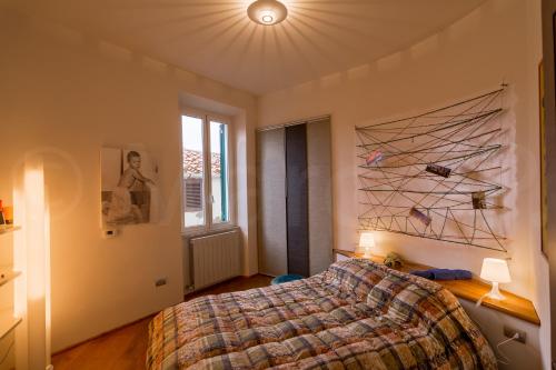 a bedroom with a bed and a large window at La Casina ad Antignano in Livorno
