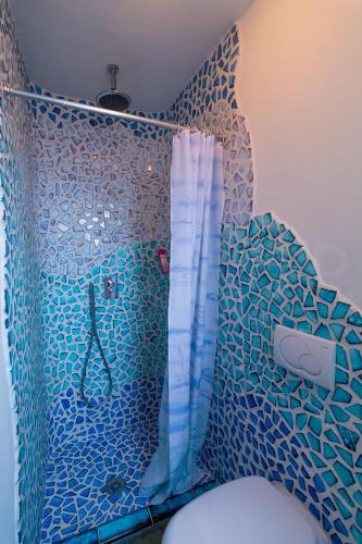 a bathroom with a shower and a toilet with a glass wall at La Casina ad Antignano in Livorno