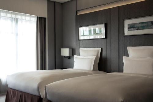 Postel nebo postele na pokoji v ubytování Pullman Shanghai Xuhui