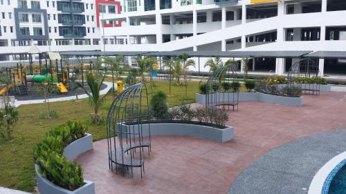 a park with a playground with chairs and plants at Mahkota Cheras Sweet Condo 1-14 pax near MRT to KL in Kuala Lumpur