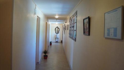 a long hallway with a hallway sidx sidx sidx sidx at Hôtel de la Poste Piscine in Peymeinade