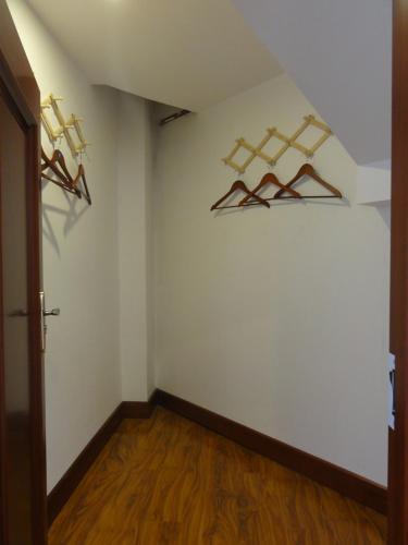 an empty room with hangers on the wall at Hua Qi Kaiserdom Hotel Zhongshan Road St Michael's Cathedral and Zhanqiao Pier Qingdao in Qingdao