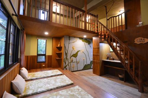a room with a staircase in a house at Amrita Green Retreat in Chaozhou