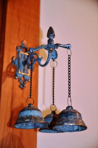 a chandelier with two bells hanging from a wall at Galexy Lounge in Burkes Pass