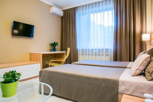 a hotel room with a bed and a window at Eco Apart Hotel Astana in Astana