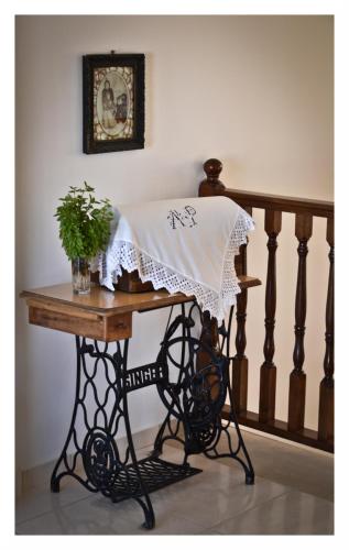 a table with a blanket on it next to a staircase at Alex in Karpathos Town