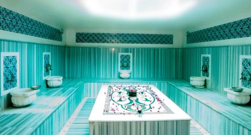 a swimming pool with a tub in the middle at Wassermann Hotel in Kemer