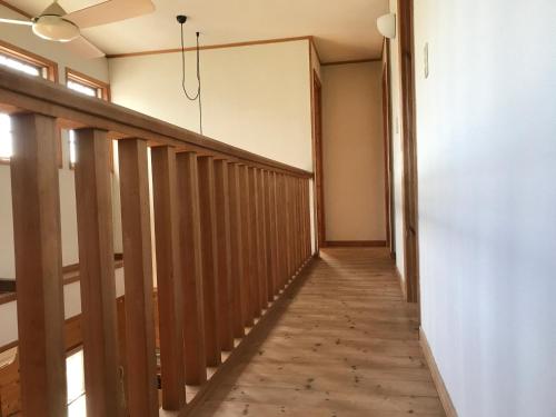 a hallway in a house with wooden floors and a ceiling at Guesthouse Irago in Tahara
