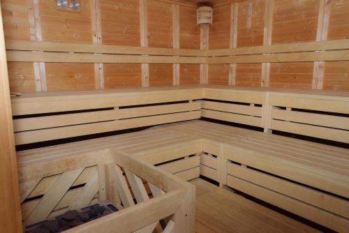a sauna with wood paneling and wooden cabinets at Hotel Deutscher Kaiser in Travemünde