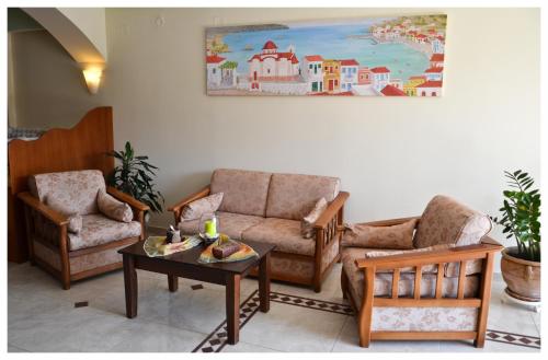 a living room with two chairs and a couch and a table at Alex in Karpathos Town