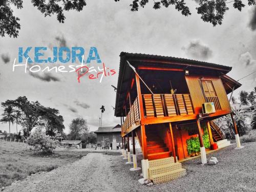 a house on a dirt road with a sign that reads kuana homes park at Kejora Homestay in Kangar