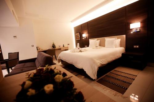 a hotel room with a bed and a couch at Radisson Hotel Sfax in Sfax