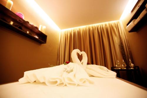 two swan towels sitting on top of a bed at Radisson Hotel Sfax in Sfax