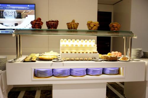 a display case with a cake and other desserts at Radisson Hotel Sfax in Sfax